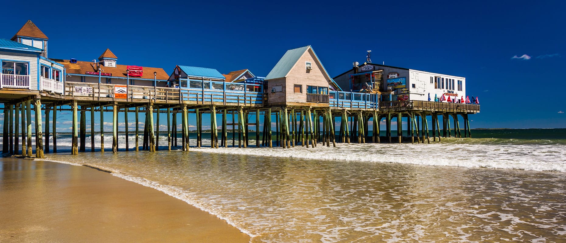 Old Orchard Beach pier at sunset, representing local businesses that benefit from dependable managed IT services.