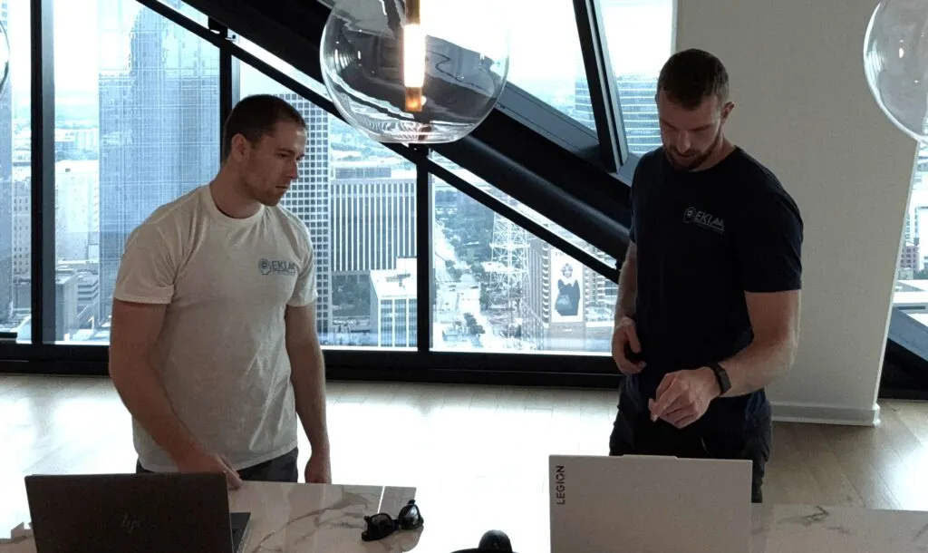 Ekim IT technicians setting up hardware during an on-site visit, delivering fast reliable IT services for a modern business workspace.