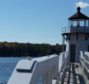 Lighthouse on the Arrowsic, Maine shoreline overlooking the water—symbolizing local connection and reliability supported by managed IT services.