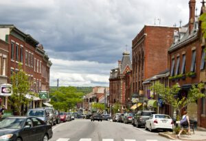 Busy downtown Belfast, Maine lined with historic brick buildings and small businesses—an evolving community embracing managed IT solutions for reliability and growth.