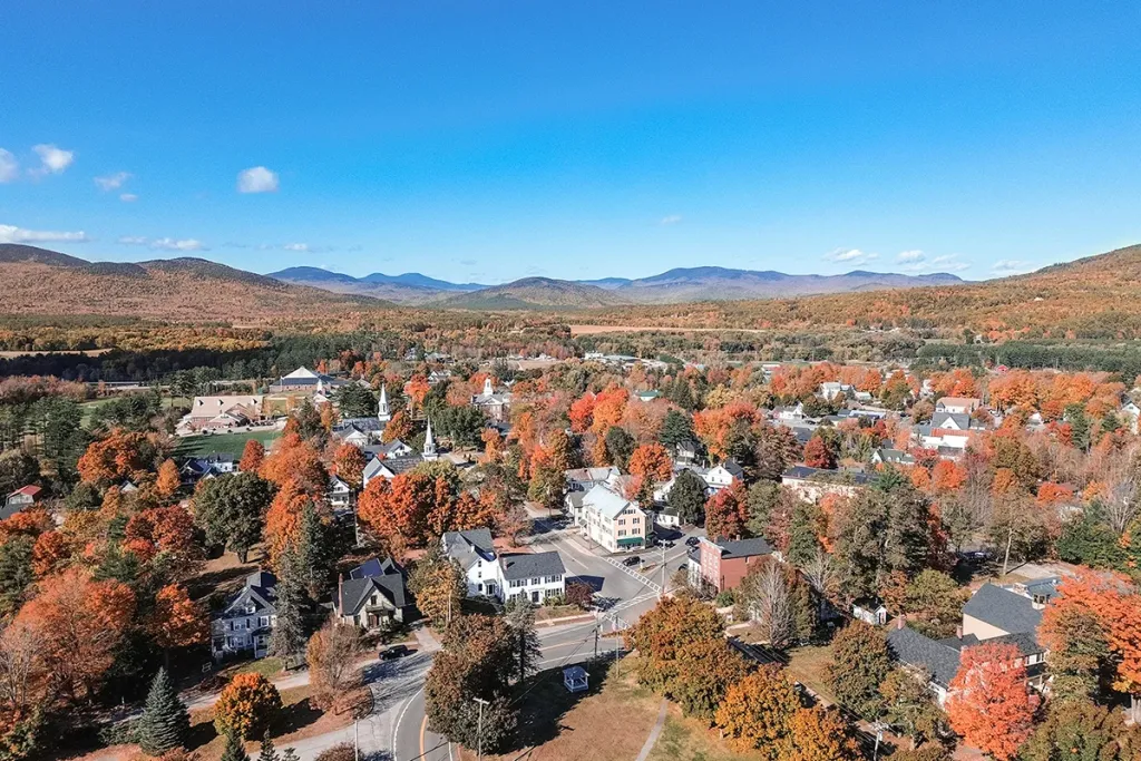 Aerial view of Bethel, Maine surrounded by fall foliage, highlighting the need for reliable managed IT services in remote and seasonal towns.