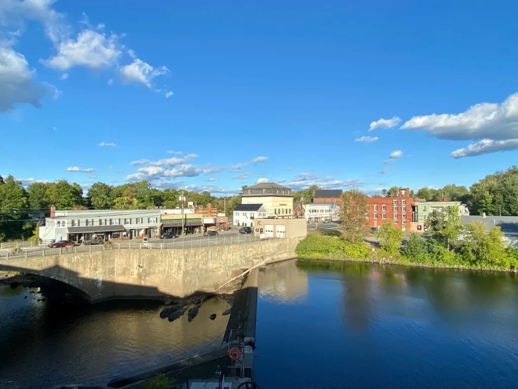 Scenic riverfront view of Dover-Foxcroft, Maine, showcasing the community where managed IT services support modern local businesses and town operations.
