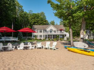 Frye Island lakeside resort with beach chairs and kayaks—highlighting the role of managed IT in supporting hospitality and guest services.