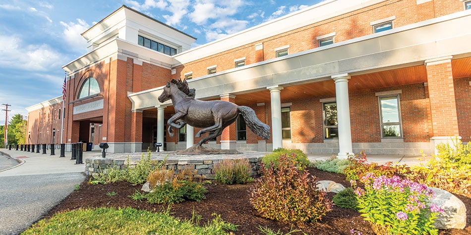 Bronze Mustang statue in front of Hampden, Maine municipal building, symbolizing the town’s strength and reliability—qualities supported by local managed IT services