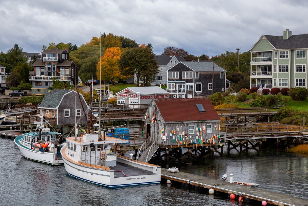 Coastal harbor in Kittery with lobster boats and homes, representing small businesses that rely on managed IT to stay productive and connected.