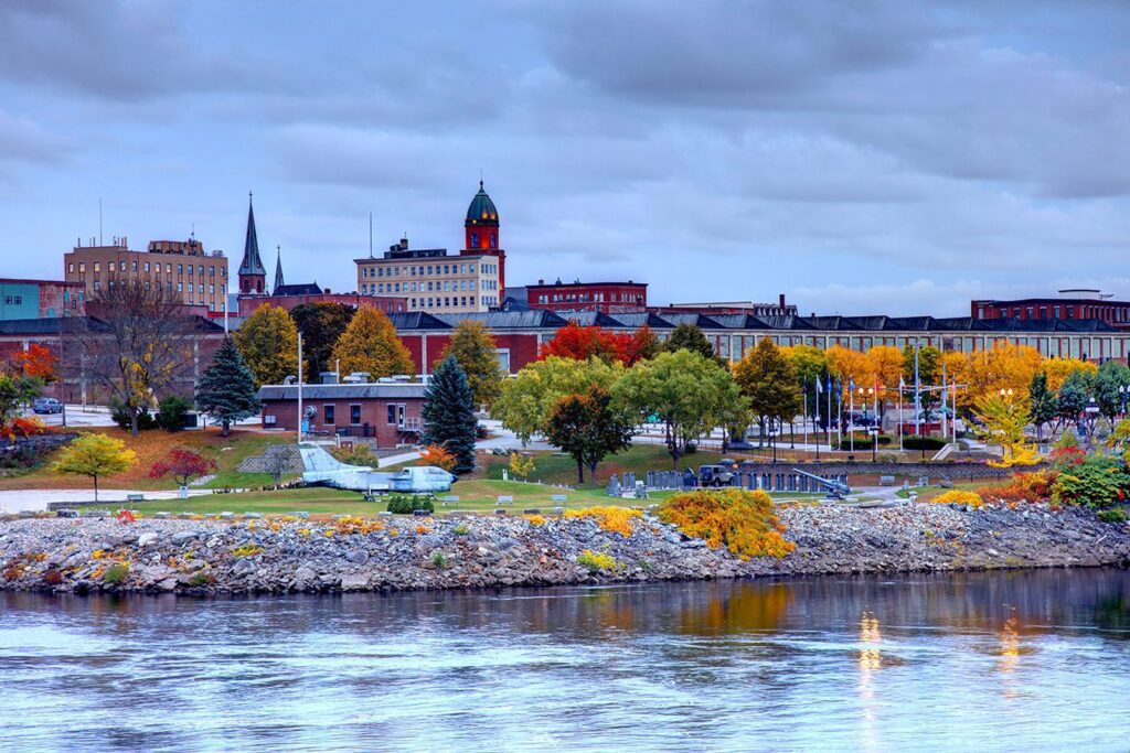 Lewiston, Maine skyline across the Androscoggin River, representing a community strengthened by reliable managed IT services.