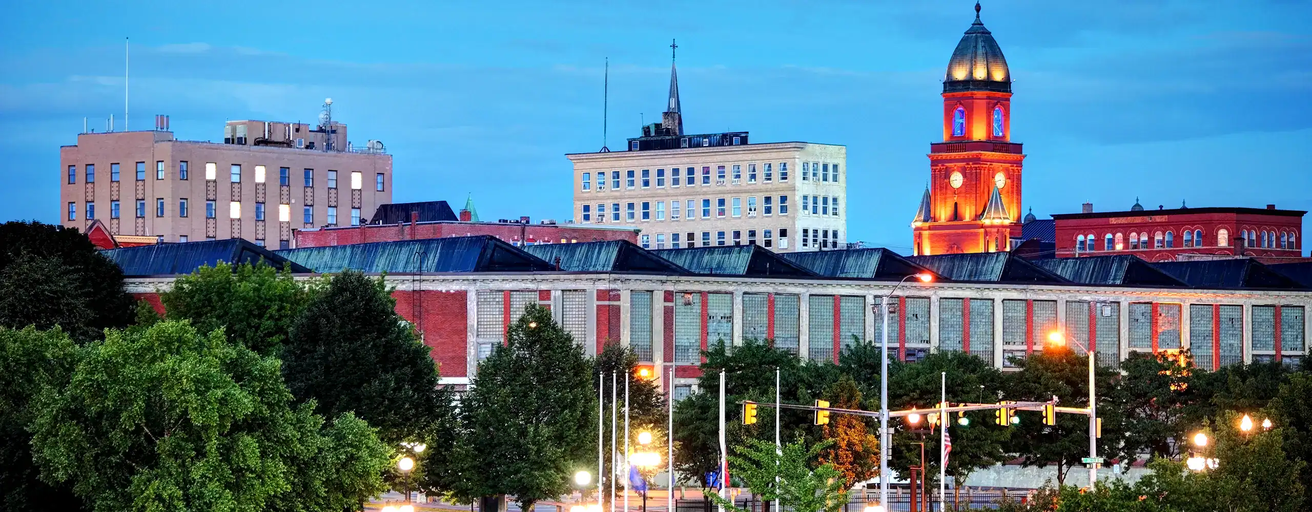Skyline view of downtown Lewiston, Maine at dusk—highlighting the vibrant community supported by managed IT solutions for local businesses and city operations.