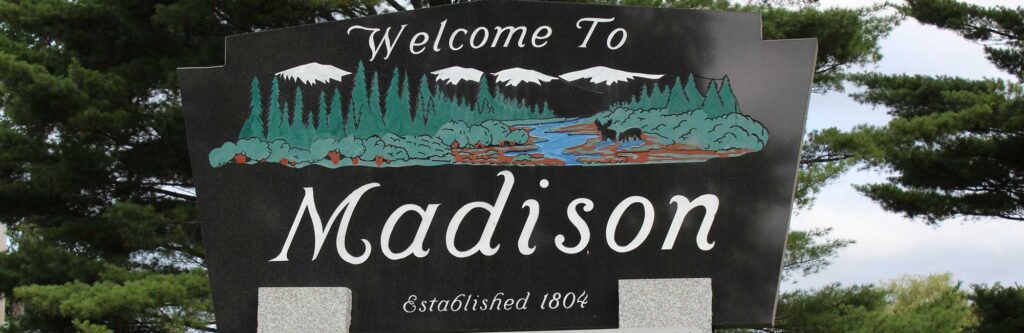 Welcome sign in Madison, Maine—local town embracing managed IT services to support small businesses and community infrastructure.