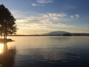 Scenic view of Millinocket Lake at sunset, representing the calm reliability and remote-ready benefits of managed IT services for rural Maine communities.