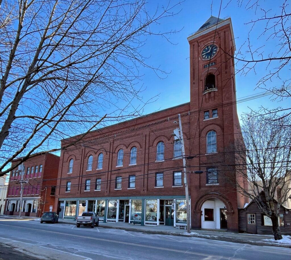 Downtown Norway, Maine with historic brick buildings and clear skies, representing a thriving local community supported by managed IT services.