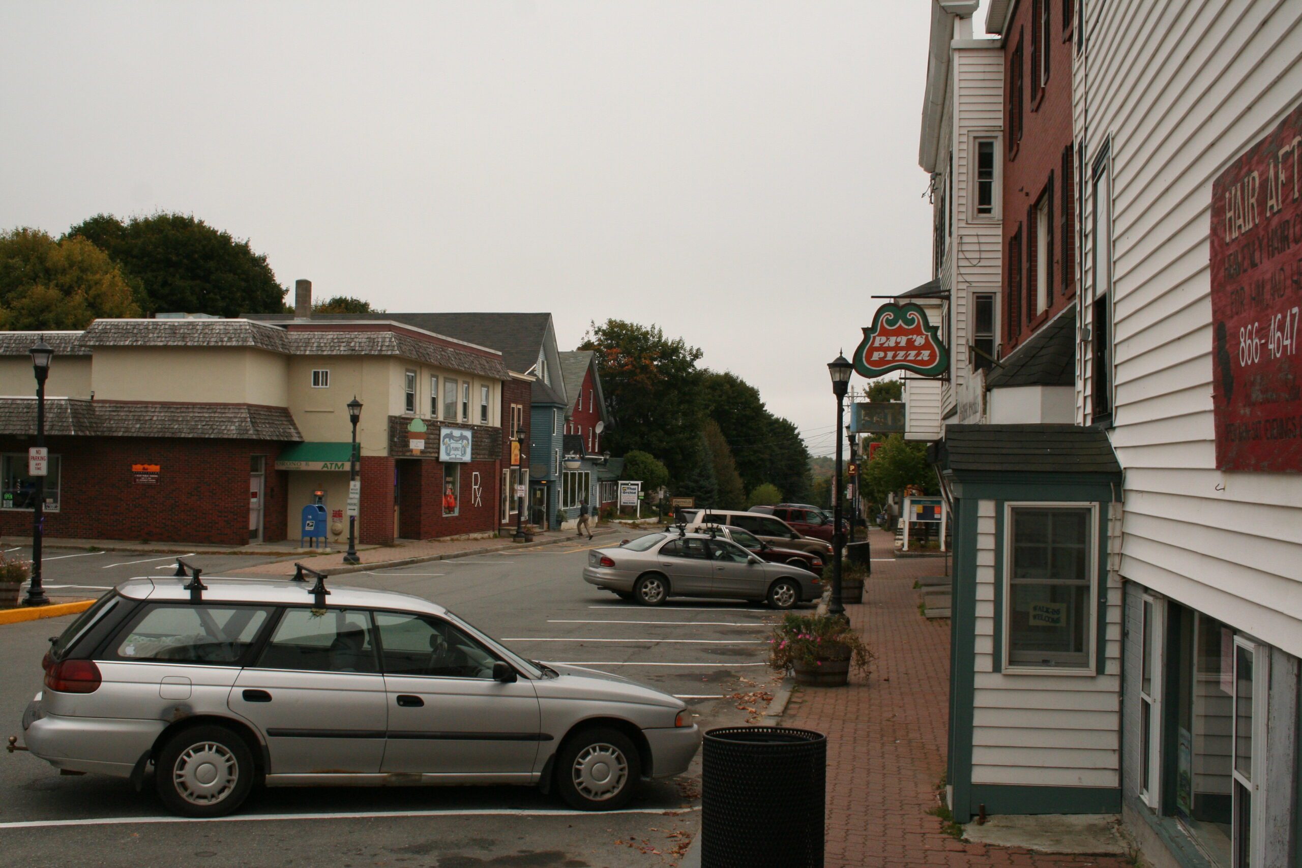 Downtown Orono street view with local businesses and cars, representing the need for managed IT support in small Maine communities.