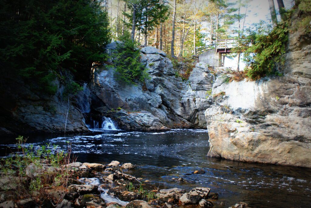Rocky stream and forested landscape in Paris, Maine—natural beauty meets modern reliability with managed IT support.