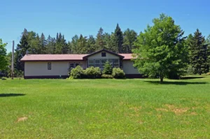 Wide grassy field and municipal building in Paris, Maine—supporting community growth with managed IT solutions.