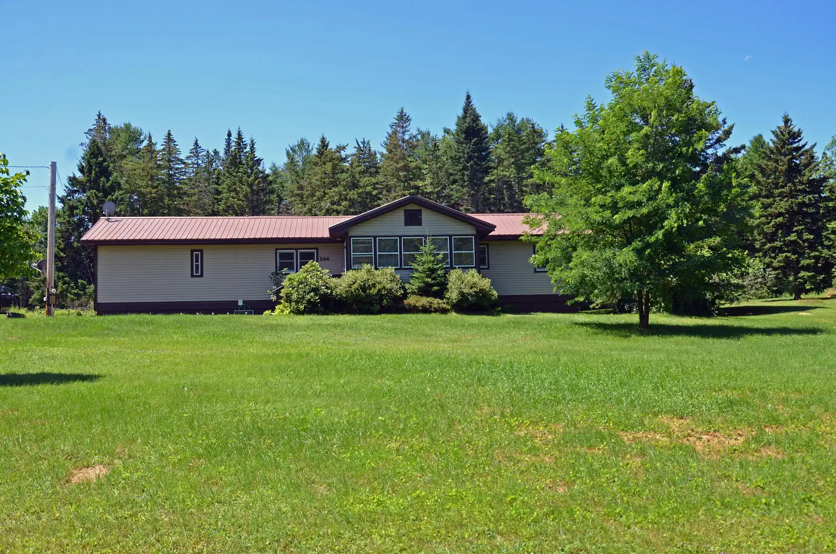 Wide grassy field and municipal building in Paris, Maine—supporting community growth with managed IT solutions.