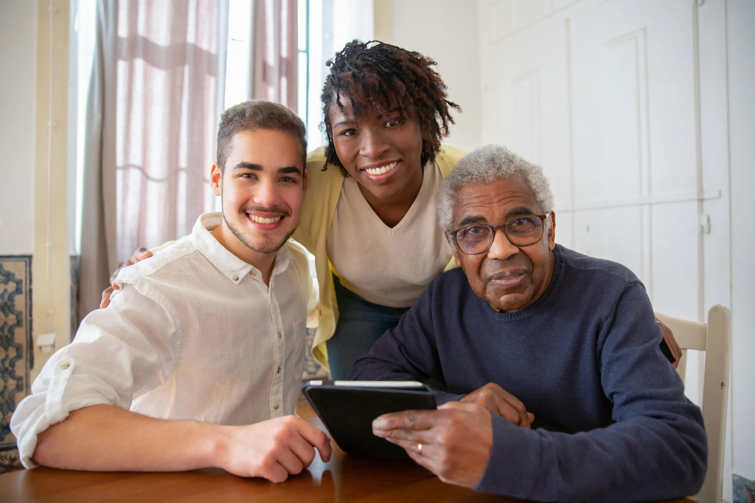 Senior residents and caregivers enjoying a smooth digital experience after resolving assisted living Wi-Fi issues.