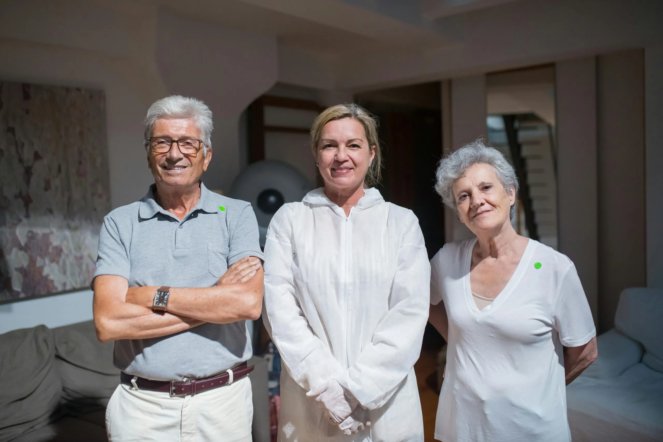 Senior living staff smiling together in a care facility—representing trust, teamwork, and the people behind quality assisted living IT support.