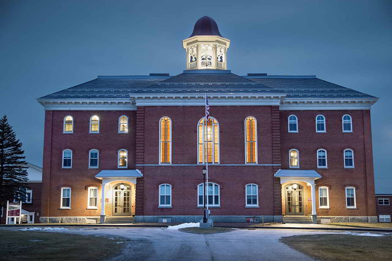 The Pittsfield town hall building illuminated at dusk—symbolizing the town’s commitment to strong civic services supported by reliable managed IT solutions.