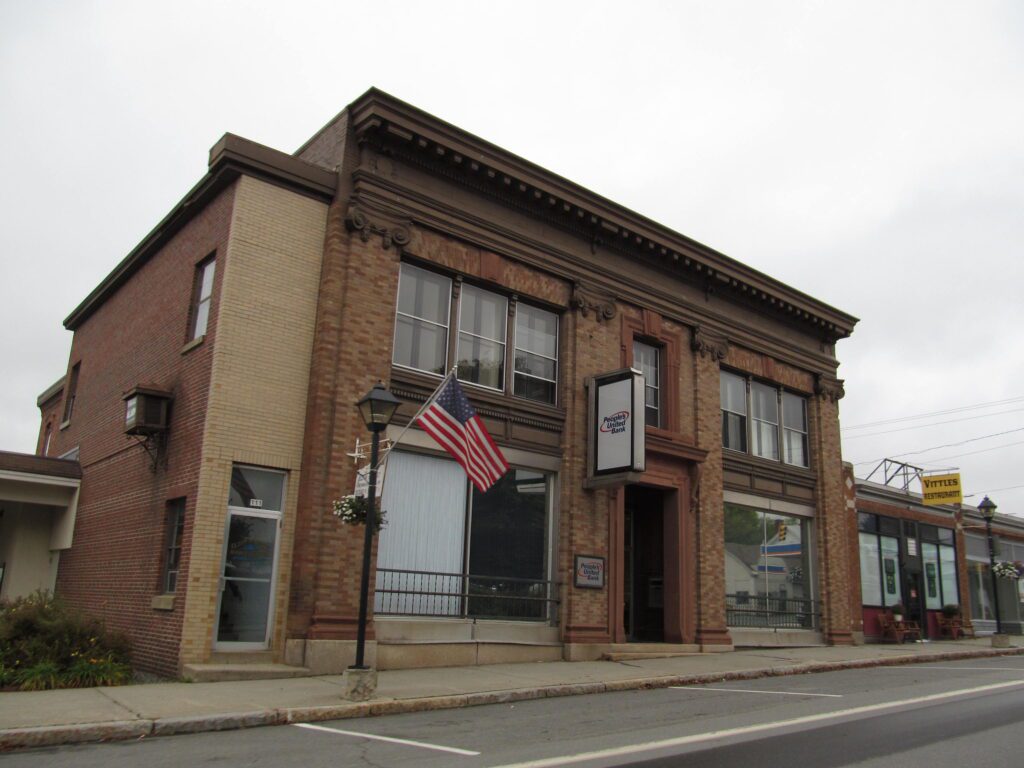 Downtown Pittsfield, Maine with brick storefronts and local businesses—representing the growing demand for managed IT solutions in small-town communities.