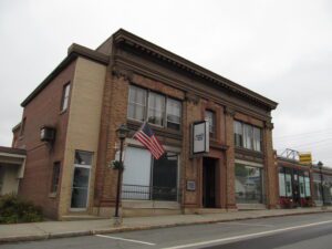 Downtown Pittsfield, Maine with brick storefronts and local businesses—representing the growing demand for managed IT solutions in small-town communities.
