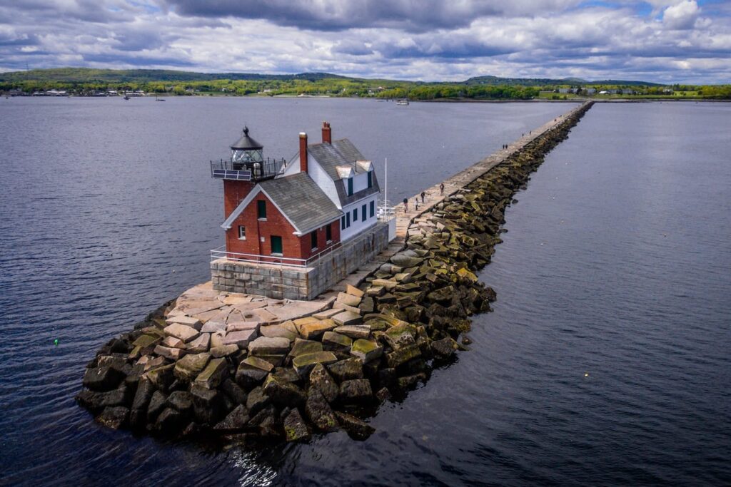 Aerial view of the Rockland Breakwater Lighthouse extending into Penobscot Bay, symbolizing steady guidance and the dependable reach of managed IT services in coastal Maine.