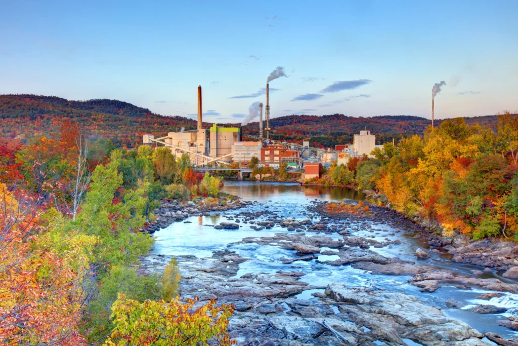 Scenic view of Rumford’s riverfront mills and fall foliage, symbolizing the town’s balance of heritage and modern managed IT growth.