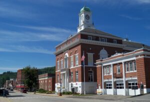 Historic brick town hall building in Rumford, Maine, under a clear blue sky—representing the community’s shift toward reliable managed IT solutions.