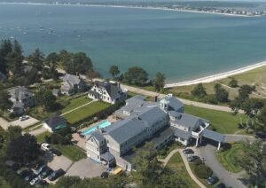 Aerial view of Scarborough, Maine's coastline with residential and commercial buildings, representing the local community supported by managed IT services.