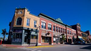 Downtown Skowhegan, Maine with historic brick storefronts under a clear blue sky—an area where local businesses increasingly rely on managed IT for dependable operations.