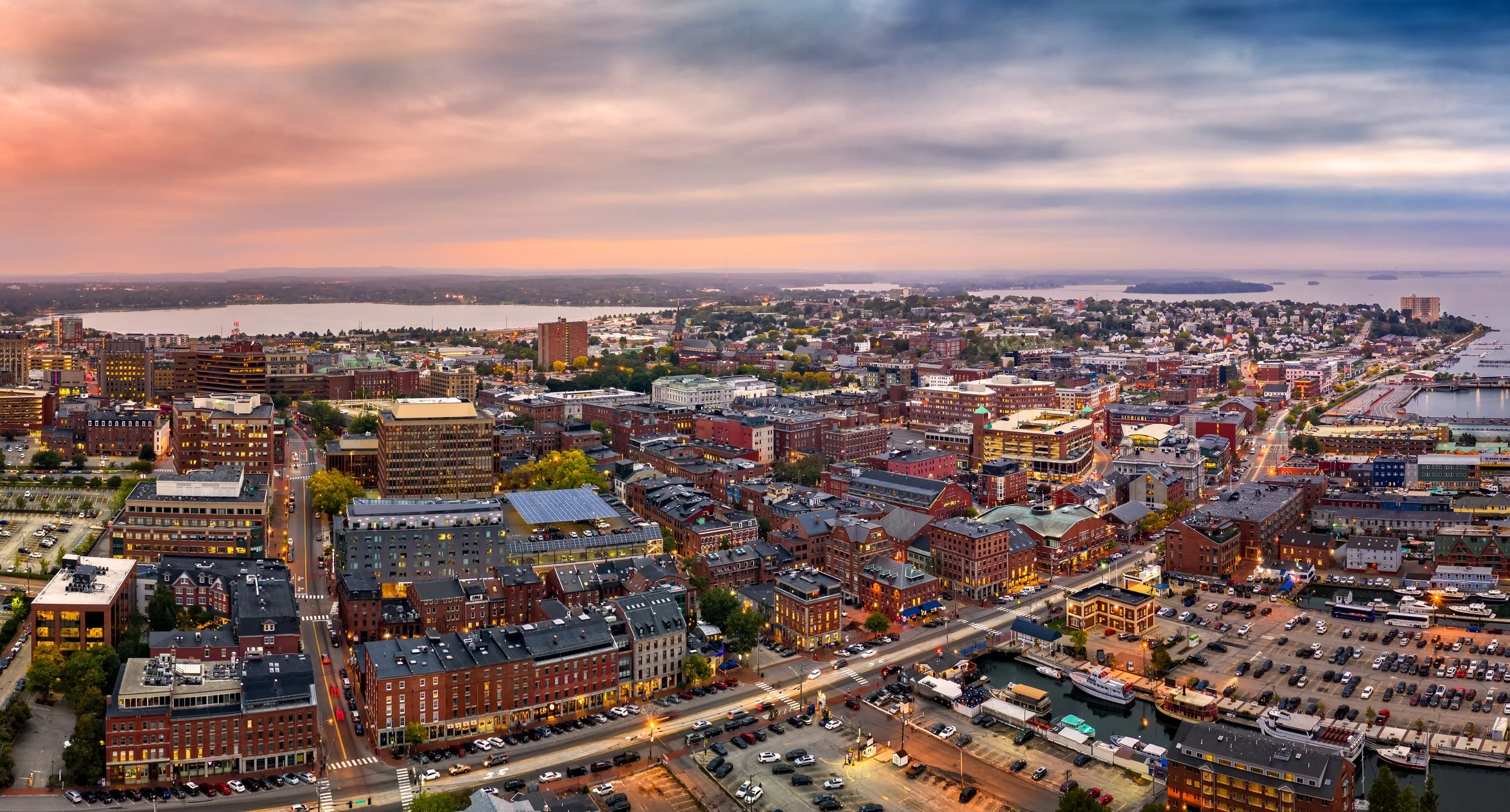 Aerial view of South Portland, Maine at sunrise, representing the city's growth and reliance on managed IT solutions for local businesses and services.