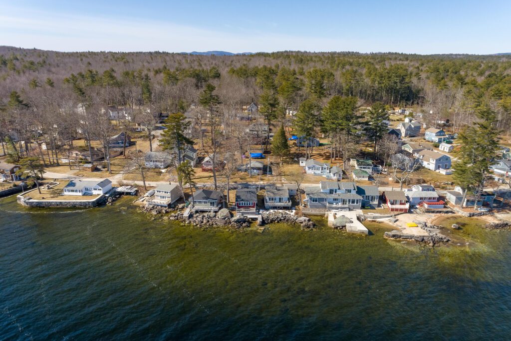 Lakeside homes and wooded shoreline in Standish, Maine, viewed from above—highlighting the need for reliable managed IT services in remote residential and business areas.