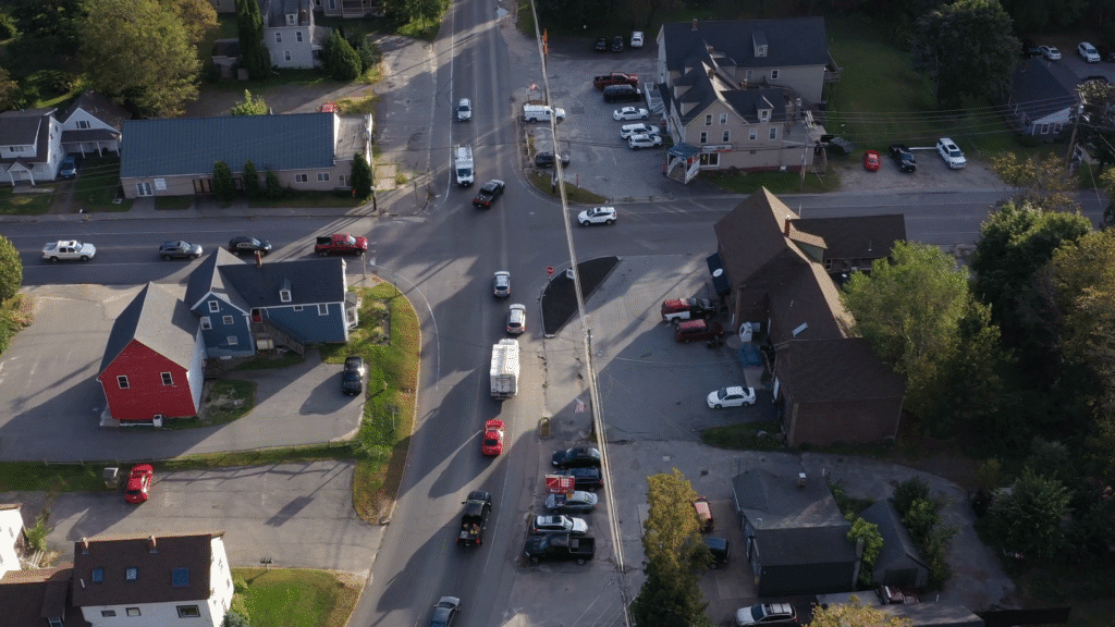 Aerial view of downtown Standish, Maine during daylight, with small businesses and residential rooftops surrounded by trees—ideal setting for managed IT support in a growing rural community.
