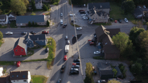 Aerial view of downtown Standish, Maine during daylight, with small businesses and residential rooftops surrounded by trees—ideal setting for managed IT support in a growing rural community.