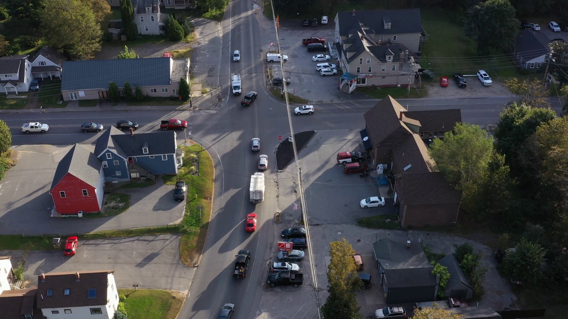 Aerial view of downtown Standish, Maine during daylight, with small businesses and residential rooftops surrounded by trees—ideal setting for managed IT support in a growing rural community.