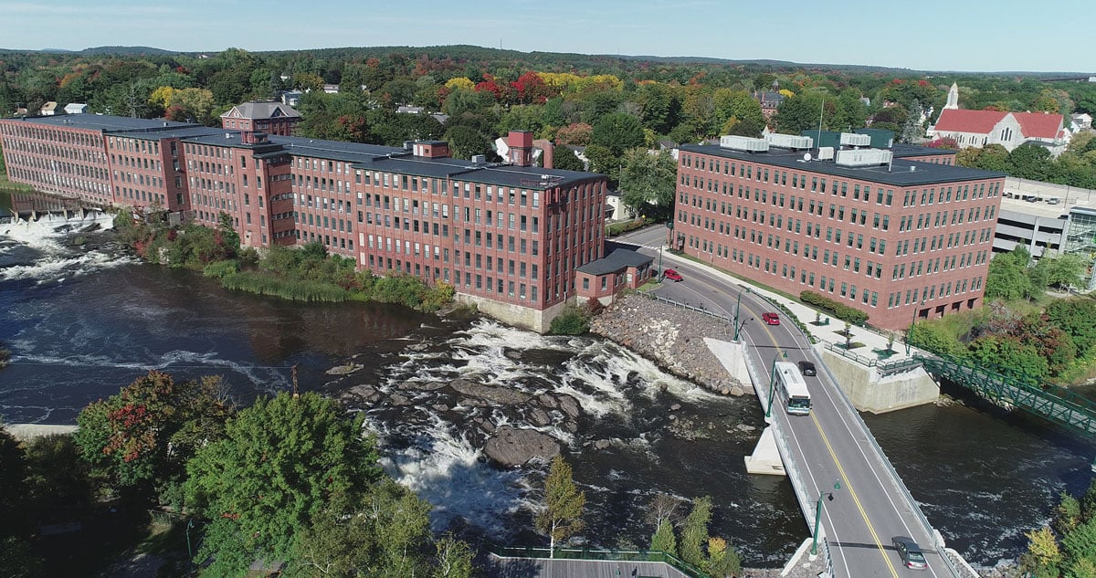 Aerial view of downtown Westbrook, Maine, showcasing the blend of historic mill buildings and modern development—an ideal setting for managed IT solutions supporting local businesses.