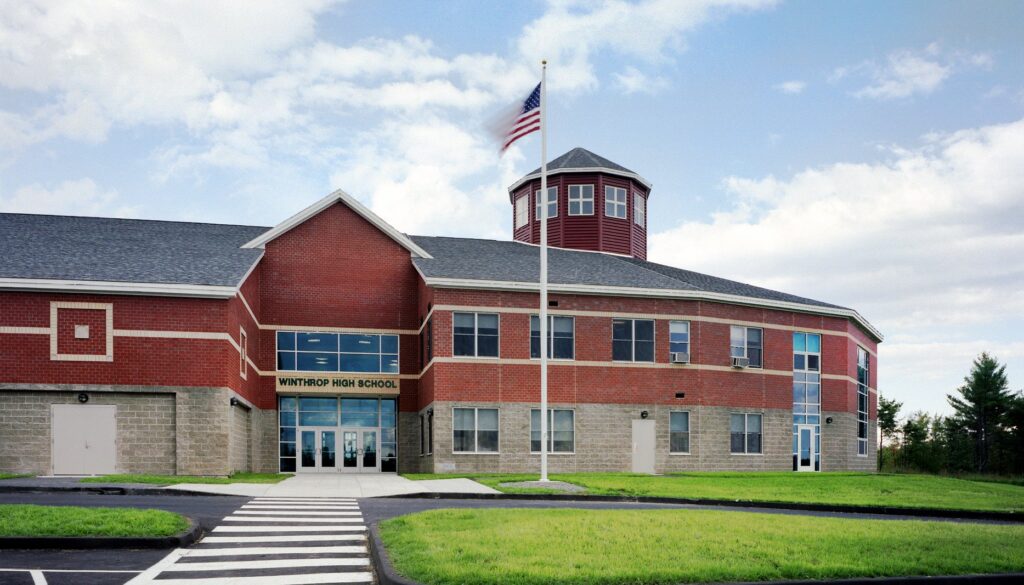 Winthrop town building under a blue sky, representing the need for reliable managed IT services in Maine communities.