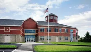 Winthrop town building under a blue sky, representing the need for reliable managed IT services in Maine communities.